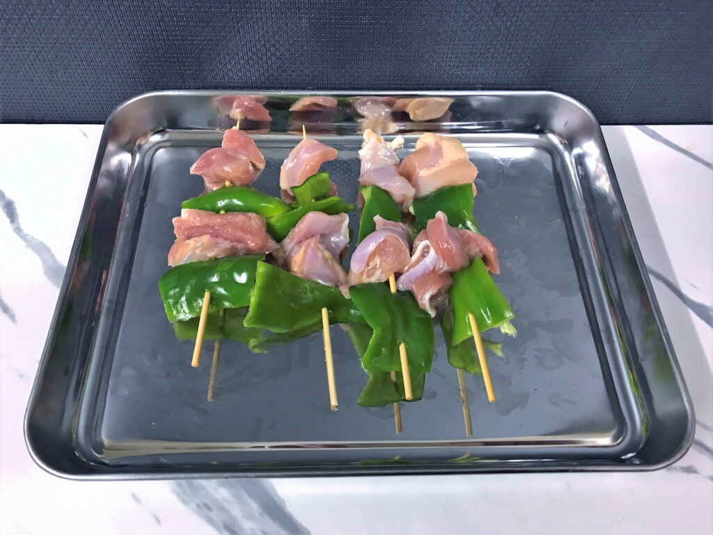 鉄板焼き用のピーマンと鶏モモ肉の串焼き